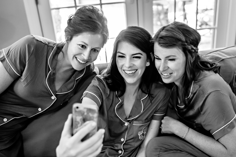 Bridesmaids taking a selfie before the wedding starts.